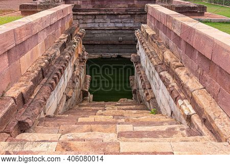 Aihole, Karnataka, India - November 7, 2013: Huchchimalli Gudi Or Temple. Stairway Down Into Green W