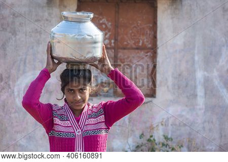 Tikamgarh, Madhya Pradesh, India - January 23, 2021: An Unidentified Indian Village Girl Carry Water