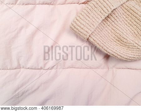 Pink Knitted Hat And Down Jacket Fabric Background, Pink Puffer Jacket Texture. Top View