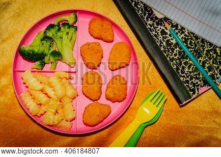 At Home Schooling Chicken Nugget Lunch Served On Tray With French Fries And Broccoli
