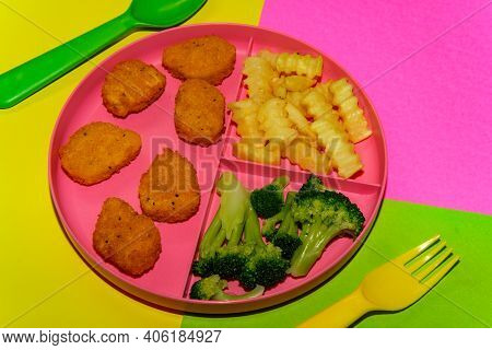 At Home Schooling Chicken Nugget Lunch Served On Tray With French Fries And Broccoli