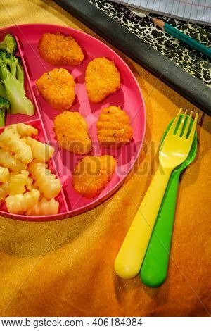 At Home Schooling Chicken Nugget Lunch Served On Tray With French Fries And Broccoli