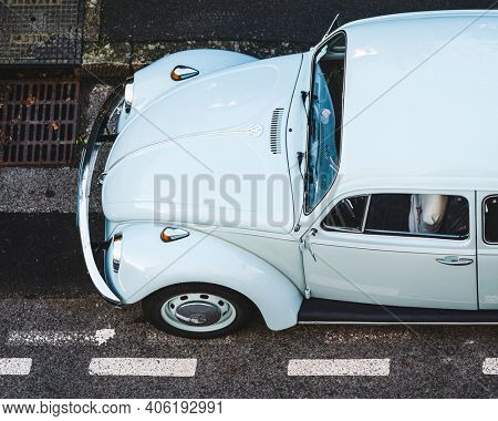 BAYONNE, FRANCE - CIRCA NOVEMBER 2020: Classic light blue Volkswagen Beetle 1300 front overhead view.