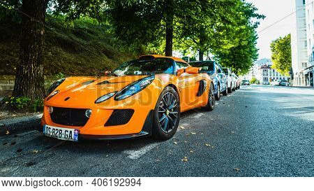 BAYONNE, FRANCE - CIRCA AUGUST 2020: An orange Lotus Exige S parked in the street.