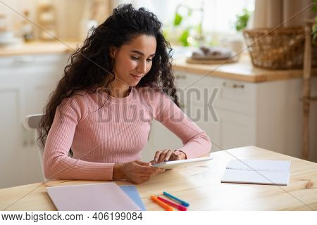 Smiling Young Woman Using Digital Tablet At Home. Millennial Brunette Lady Study Or Work Online With