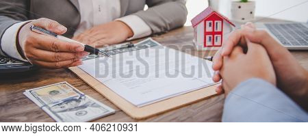 House Signers Signing Signature Loan Document To Home Ownership With Real Estate Agents Ownership. M