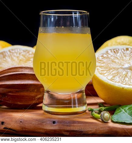 Glass Of Ice Cold Sweet Limoncello Liqueur Made From New Harvest Of Fresh Ripe Yellow Italian Lemons