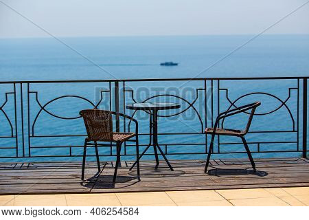 Chairs And Table On Protected Terassa By Sea