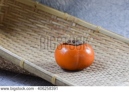 Closeup Of Fresh Persimmon Fruit Which Bright Red Orange In Color. It Is Available In East Asian Cou