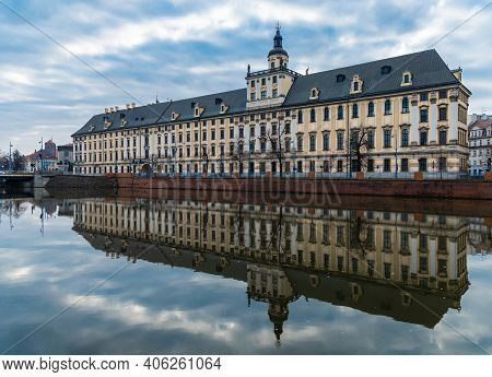 Wroclaw, Poland - March 19 2020 Facade Of University Of Wroclaw At Cloudy Morning Reflected In Silen