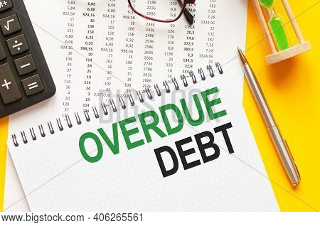 Writing Text Showing Overdue Debt. Writing Text Overdue Debt On White Paper Card, Green And Black Le