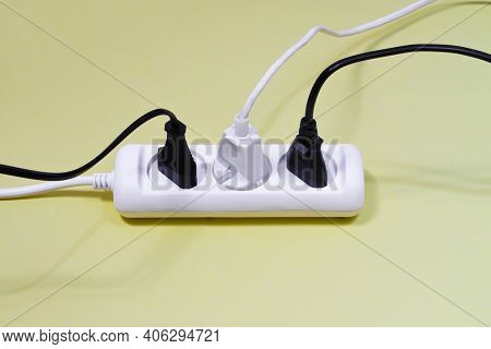 Side View Of The White And Black Electrical Wires From The Extension Cord Stuck In The Adapter. A Me