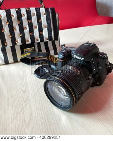 Perm, Russia, June  2020. Photo Camera Nikon D750 And Striped Bag On Table In Room