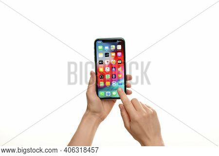 Mykolaiv, Ukraine - July 9, 2020: Woman Holding  Iphone X With Home Screen On White Background, Clos