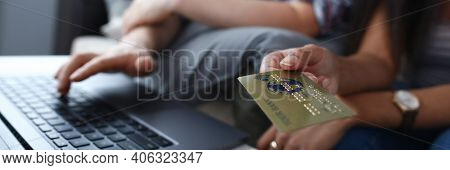 Close-up Of Happy Couple Shopping Online Using Plastic Credit Card. Man Searching For Something On L