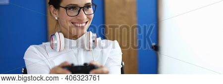 Portrait Of Cheerful Young Woman Playing Video Game With Headset On Neck. Happy Pretty Female Relaxi