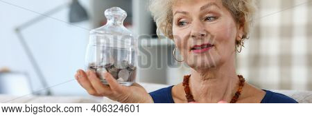 Portrait Of Senior Attractive Woman Holding Pink Piggy-bank. Elderly Female And Glass Container For 