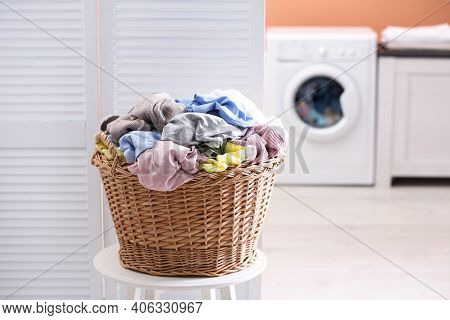 Wicker Basket With Dirty Laundry In Room