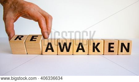 Reawaken Symbol. Businessman Turns Cubes And Changes The Word 'awaken' To 'reawaken'. Beautiful Whit