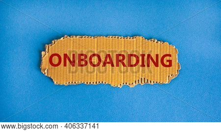 Onboarding Symbol. The Concept Word 'onboarding' On The Piece Of Cardboard. Beautiful Blue Backgroun