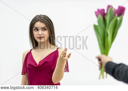 Beautiful Woman With Snobbish Expression, Looking With Skeptical Expression At The Bunch Of Tulips H
