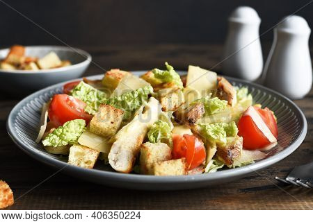 Caesaor Salad. Salad With Romaine Leaves, Chicken And Tomans In A Plate. Horizontal Focus.