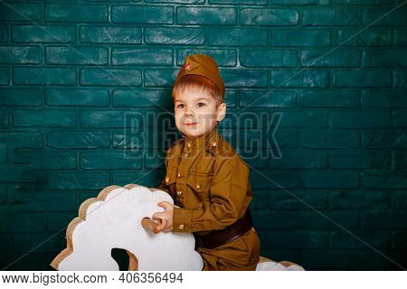 Kid Riding White Horse. Child In A Suit. The Boy Is Preparing To Learn Pony Riding. Portrait Of Litt