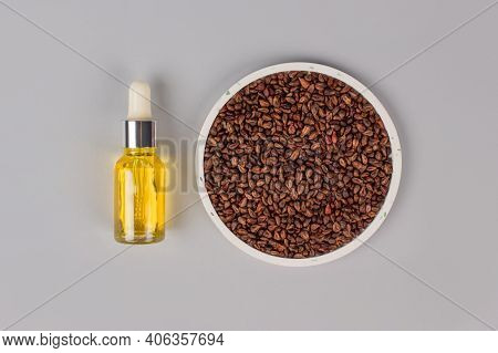Grapeseed Oil With Grape Pits On Gray Background With Copy Psace. Pillow For Spa Massage - Natural H