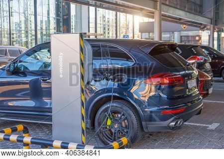 Porsche Turbo Hybrid Electric Car Charging With High Power Charging Technology. Russia, Saint-peters