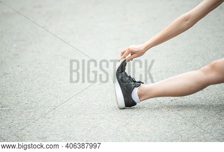 Cropped Shot View Of Runner Woman Doing Stretching And Warming Up Her Legs Before Running. The Benif