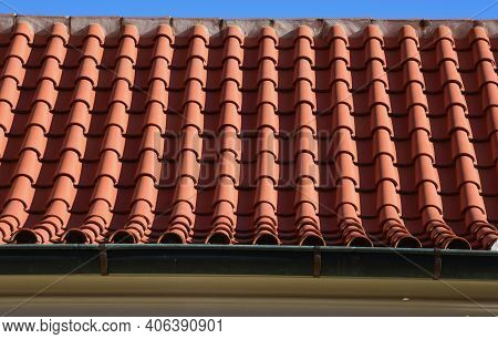 The Trough Of Two Roofs Bent Into A Turn With Italian Folded Tiles And A Metal Gutter. You Can See T