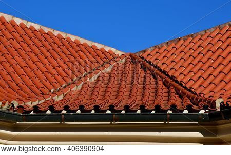 The Trough Of Two Roofs Bent Into A Turn With Italian Folded Tiles And A Metal Gutter. You Can See T