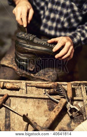 detail of cobbler at work vintage colours