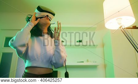 Young Woman With Vr Headset Experiencing Virtual World For First Time. High Quality Photo