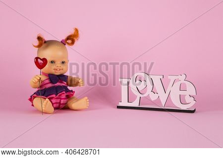 Freckled White Doll Girl With Two Curly Red Tails Holds A Heart  On A Pink Background With The Inscr