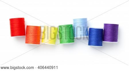 Sewing Threads Arranged Like Rainbow Colors Isolated On White Background. Top View