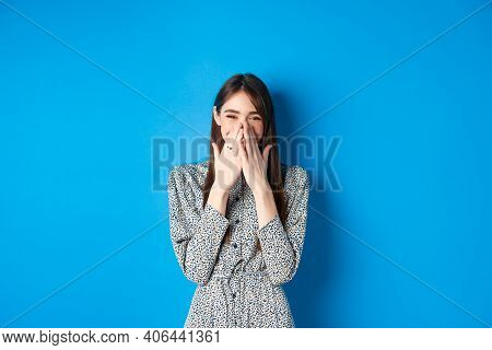 Cheerful Caucasina Girl In Dress Laughing And Having Fun, Covering Mouth With Hands And Chuckle Over