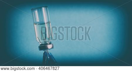 The Concept Of Vaccination. Close-up, Banner. An Ampoule Of Medicine, Turned Upside Down, And Five M