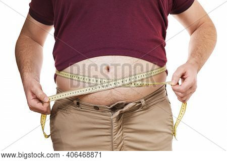 Overweight Man Measures His Waist With A Measuring Tape, Isolated On White Background. Concept On Th