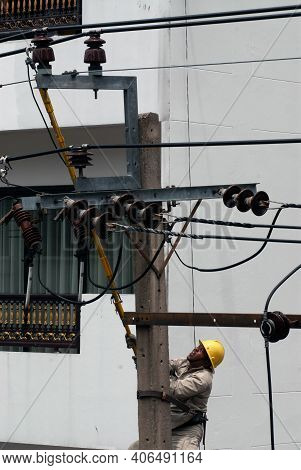 Bangkok,thailand - January 18,2011 : Unidentified Electrician Climbed An Electric Pole, Repaired Dam
