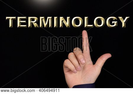 Terminology Text, A Word Written On A Black Background Pointed To By A Hand With The Index Finger Of