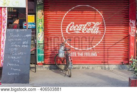Chitwan, Nepal - November 09, 2019: Coca Cola Logo On The Facade Of A Store In Sauraha, Nepal