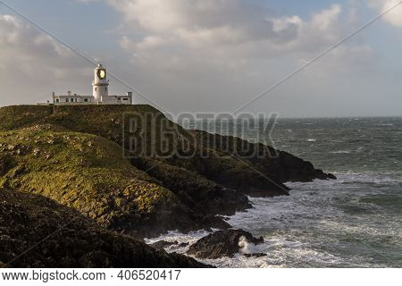 Stormy Sea At Strumble Head With Lighthouse, Pembrokeshire, Wales, United Kingdom