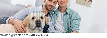 Joyful Same Sex Couple Smiling Near Dog, Banner.