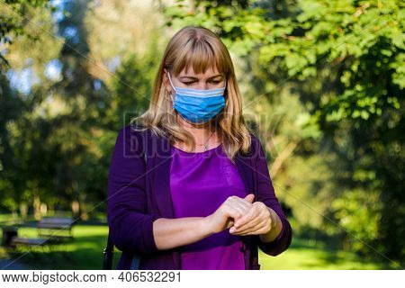 Defocus Hands Of Female In Medical Mask Cleaning Her Hands With Sanitizer Outdoor In The Park To Pre