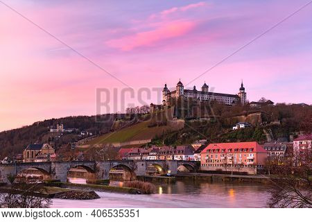 View Of Marienberg Fortress And Old Main Bridge, Alte Mainbrucke In Wurzburg At Pink Sunset, Bavaria