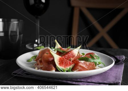 Delicious Figs And Proscuitto On Black Table