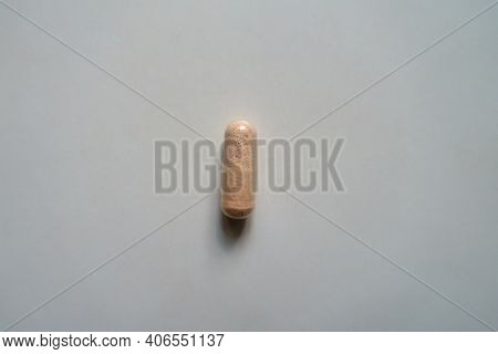 Top View Of Pink Capsule Of Probiotic Dietary Supplement