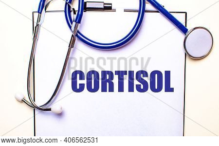 The Word Cortisol Is Written On A White Sheet Near The Stethoscope. Medical Concept