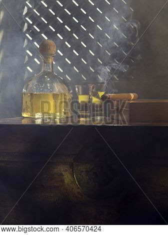 Close Up View Of Bottle Of Tequila Anejo And Cigar On Color Background